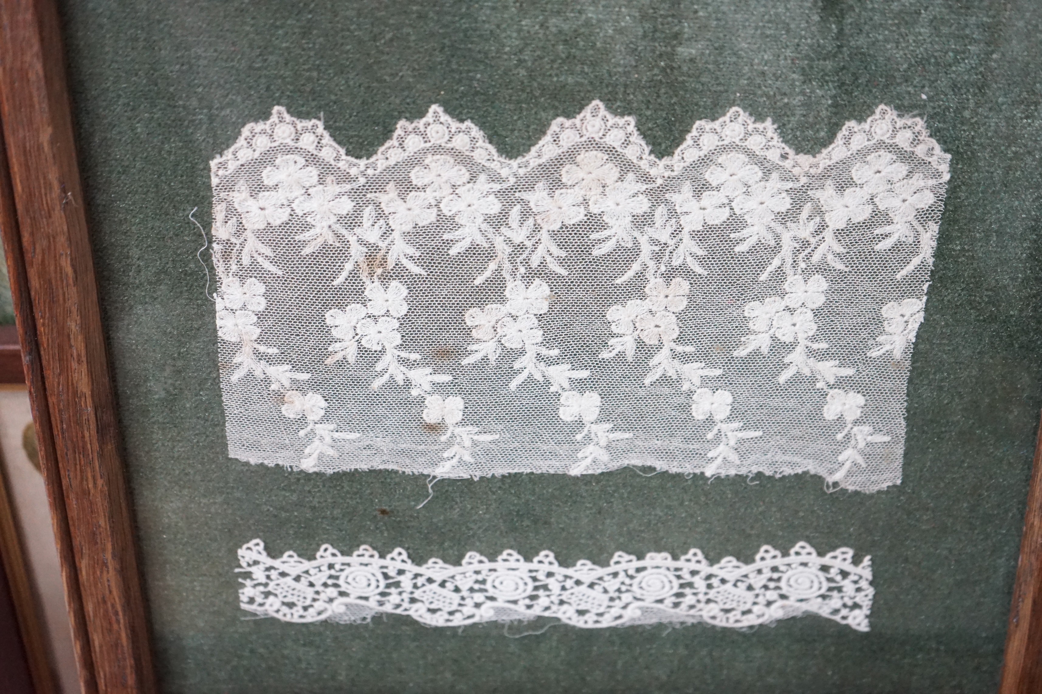 Eight framed embroideries / lace panels including a sampler